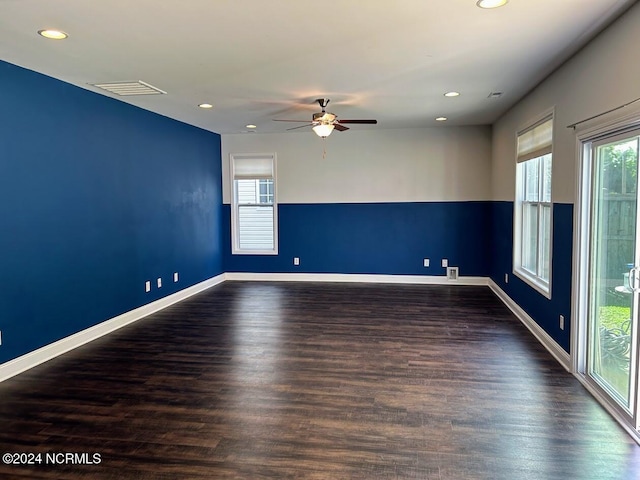 unfurnished room with dark hardwood / wood-style floors and ceiling fan