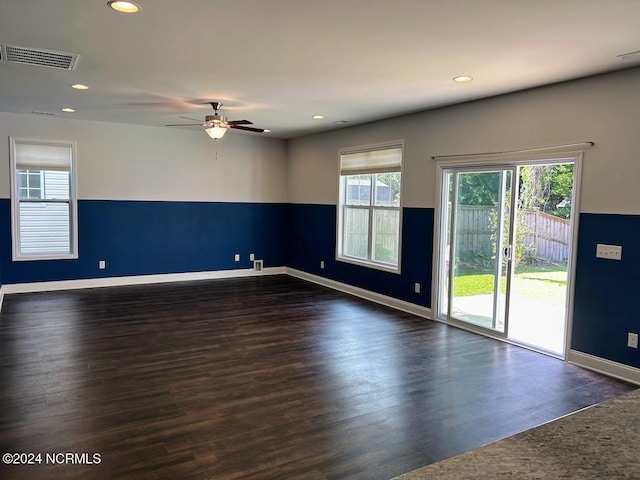 unfurnished room with ceiling fan and dark hardwood / wood-style floors