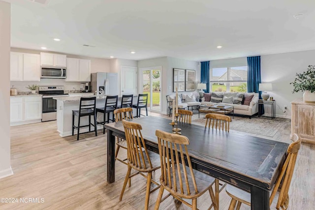 dining area with light hardwood / wood-style flooring