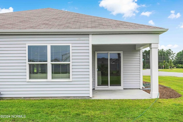 back of property with a patio area and a lawn