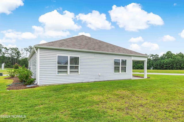 view of side of home with a yard