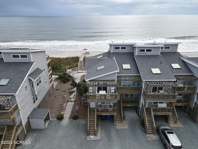 birds eye view of property featuring a view of the beach and a water view