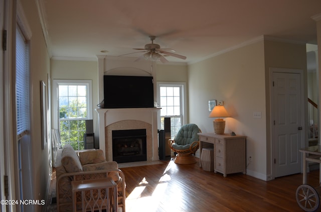 living room with ceiling fan, a healthy amount of sunlight, ornamental molding, and hardwood / wood-style floors