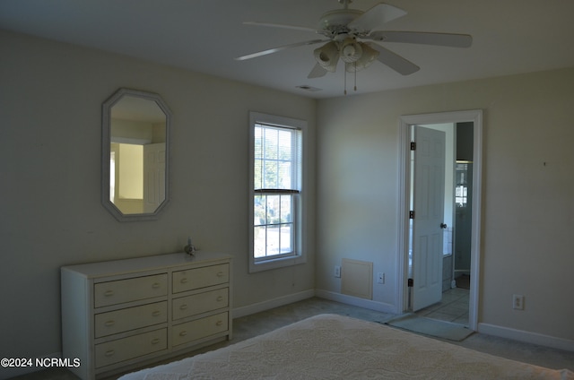 unfurnished bedroom featuring connected bathroom, ceiling fan, and light carpet