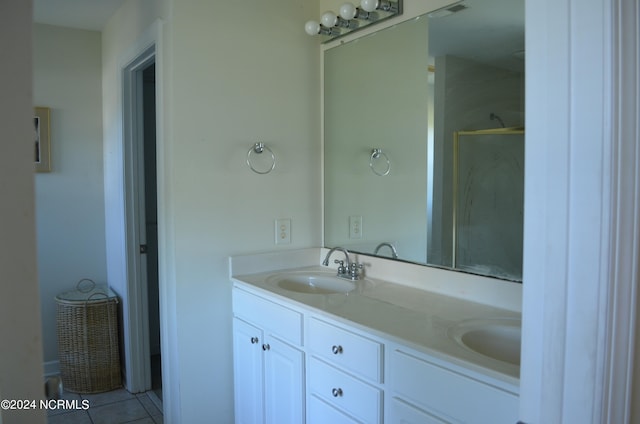 bathroom featuring vanity, a shower, and tile patterned flooring