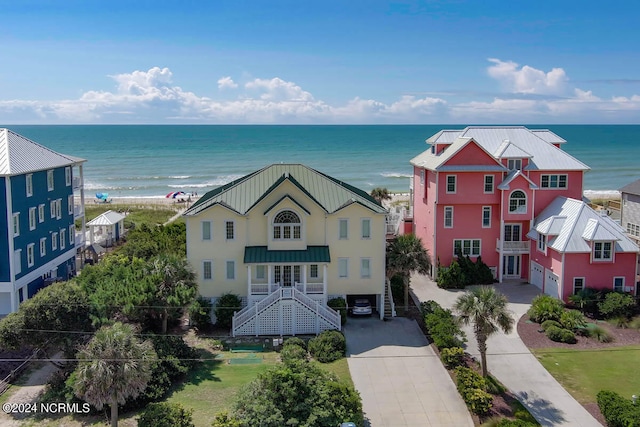 bird's eye view featuring a water view and a beach view