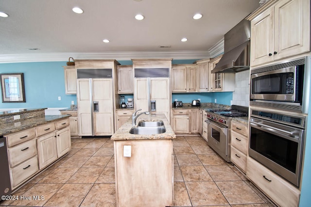 kitchen featuring ornamental molding, built in appliances, light stone counters, and a kitchen island with sink