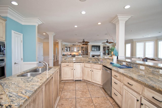 kitchen with ornamental molding, stainless steel appliances, sink, and ornate columns