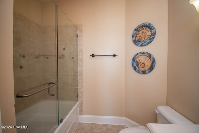 full bathroom featuring toilet, bath / shower combo with glass door, vanity, and tile patterned flooring