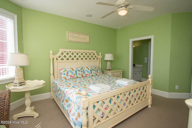 carpeted bedroom with ceiling fan and ensuite bath