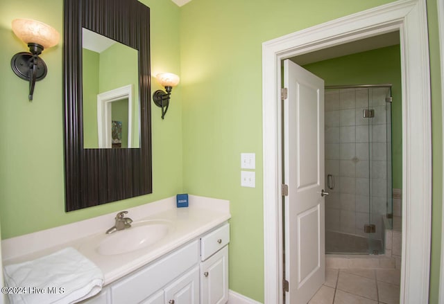 bathroom featuring a shower with door, vanity, and tile patterned floors