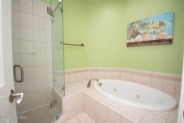 bathroom featuring shower with separate bathtub