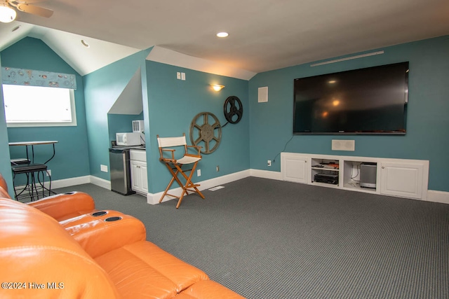 living room featuring carpet flooring, vaulted ceiling, and ceiling fan