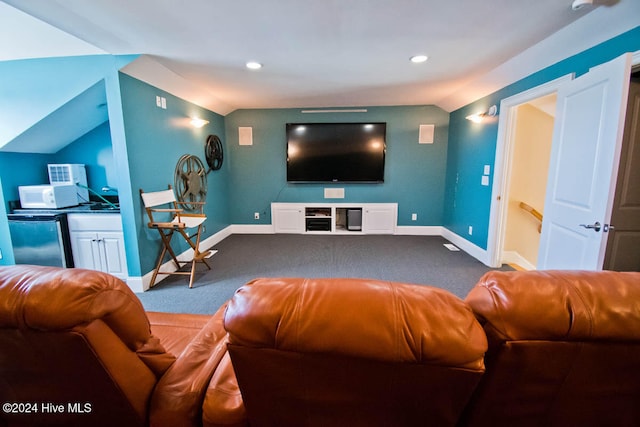 carpeted home theater room featuring lofted ceiling