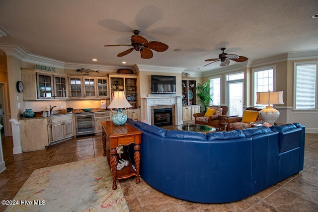 living room featuring ornamental molding, beverage cooler, and ceiling fan