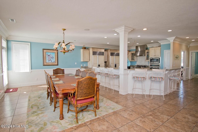 dining room featuring an inviting chandelier, ornamental molding, and light tile patterned floors