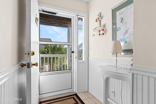 entryway with light tile patterned floors and plenty of natural light