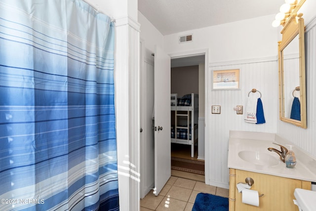 bathroom featuring vanity, a textured ceiling, and tile patterned floors