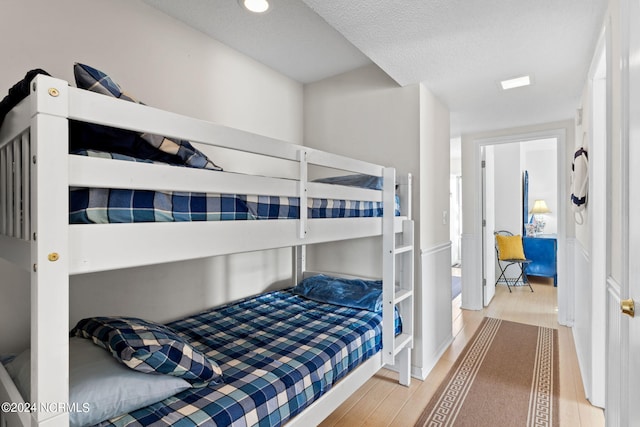 bedroom featuring a textured ceiling and wood-type flooring