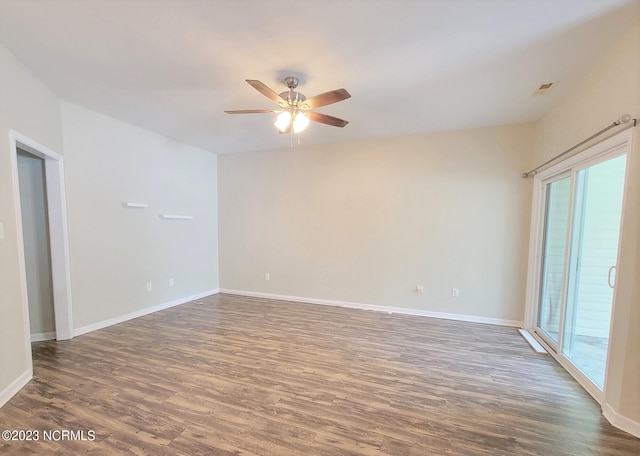 spare room with dark hardwood / wood-style floors and ceiling fan