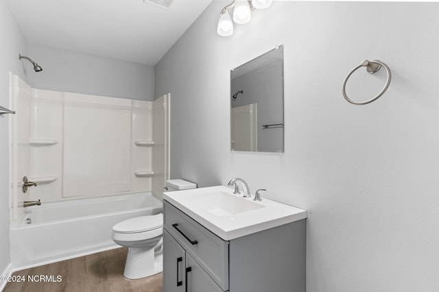 full bathroom with vanity, toilet, bathtub / shower combination, and hardwood / wood-style floors