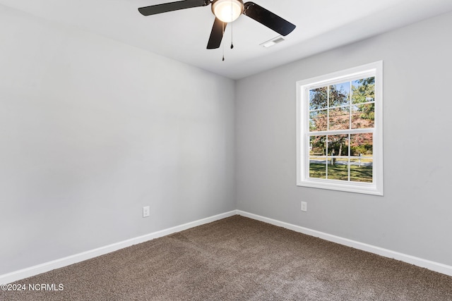 carpeted spare room with ceiling fan