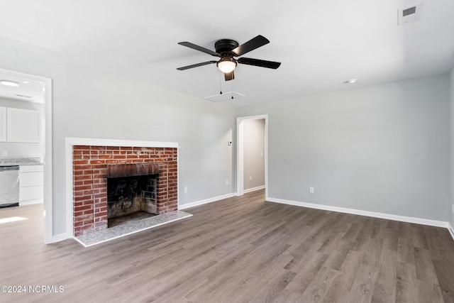 unfurnished living room with light hardwood / wood-style flooring, a fireplace, and ceiling fan