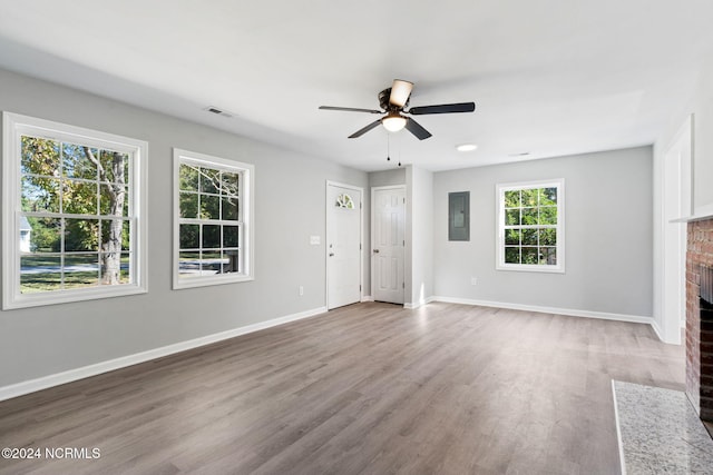 unfurnished living room featuring a fireplace, hardwood / wood-style flooring, and plenty of natural light