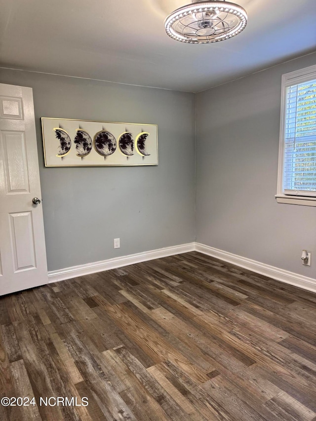 spare room with dark wood-type flooring