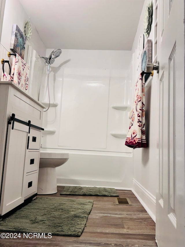 full bathroom with vanity, hardwood / wood-style floors, bathing tub / shower combination, and toilet