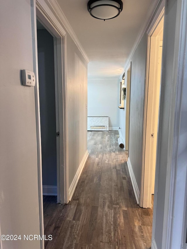 corridor with ornamental molding and dark hardwood / wood-style flooring