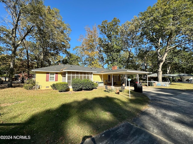 view of front of property with a front yard and a sunroom