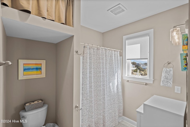 full bathroom featuring toilet, baseboards, and visible vents