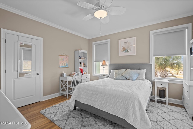 bedroom featuring crown molding, baseboards, a ceiling fan, and light wood-style floors