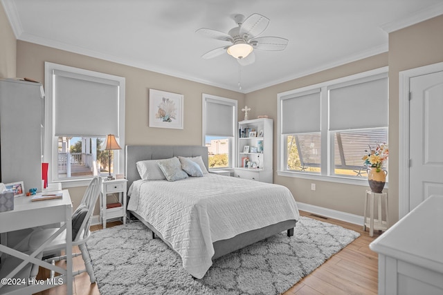 bedroom with baseboards, ornamental molding, visible vents, and light wood-style floors