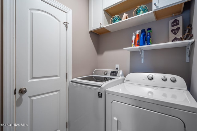 laundry room featuring cabinet space and separate washer and dryer