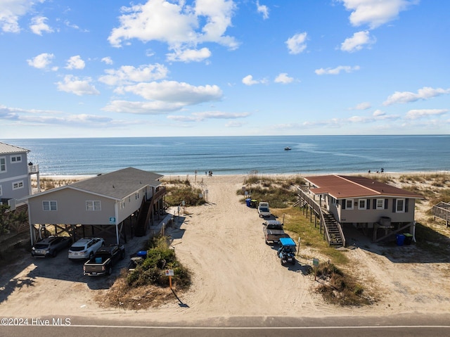 birds eye view of property featuring a water view and a view of the beach