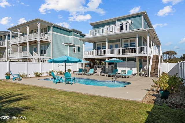 back of house with a fenced in pool, a patio, a balcony, stairway, and fence