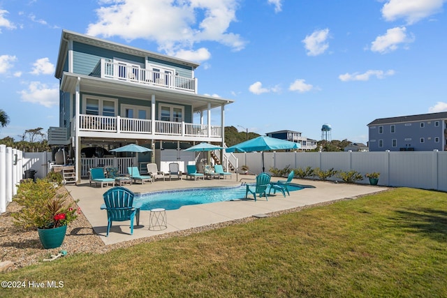 back of house with a patio, a fenced backyard, a balcony, and a fenced in pool