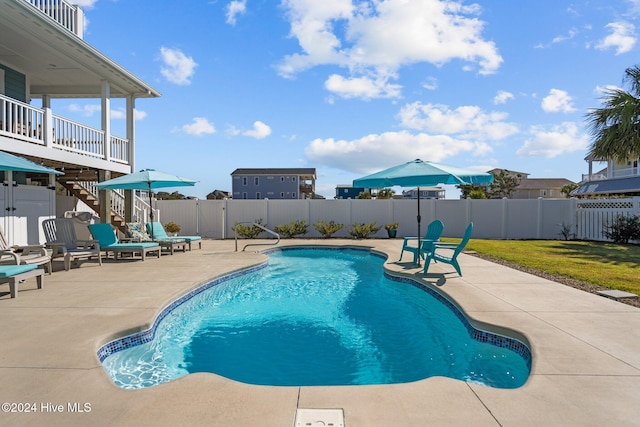 view of pool featuring a fenced in pool, a fenced backyard, a patio, and stairway