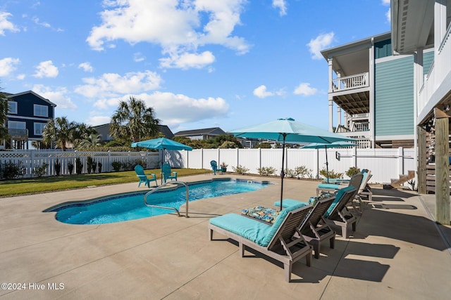 view of swimming pool featuring a patio area, a fenced backyard, and a fenced in pool