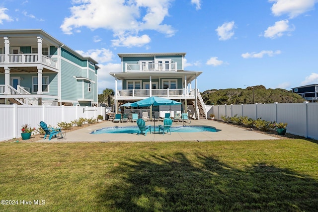 rear view of house with a patio area, a fenced backyard, stairway, and a fenced in pool