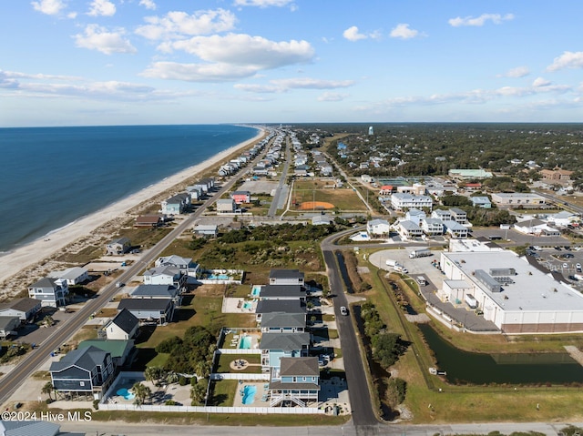 birds eye view of property with a water view, a residential view, and a view of the beach