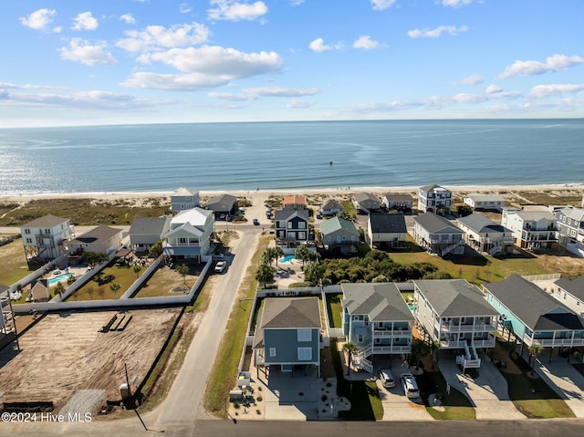 aerial view with a residential view, a water view, and a beach view