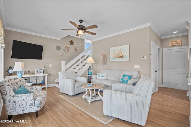 living room with ceiling fan, baseboards, stairs, light wood finished floors, and crown molding