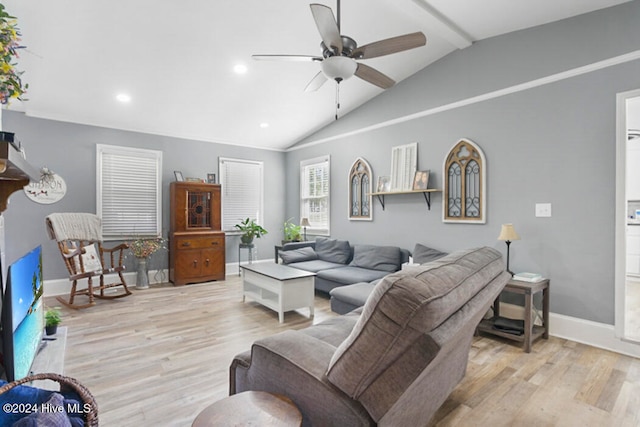 living room with ceiling fan, vaulted ceiling, and light wood-type flooring