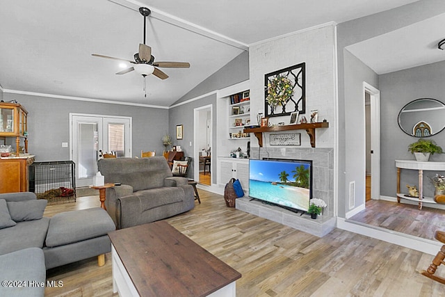 living room with light wood-type flooring, a fireplace, built in features, ceiling fan, and lofted ceiling