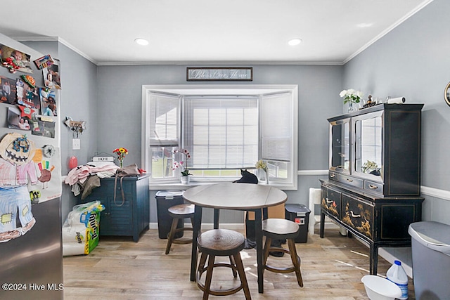 recreation room featuring ornamental molding and light hardwood / wood-style floors