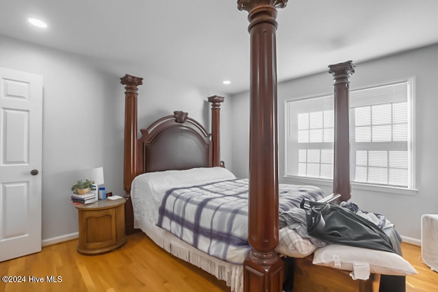 bedroom with hardwood / wood-style flooring