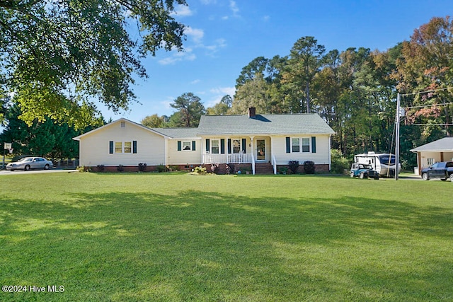 single story home featuring a porch and a front lawn